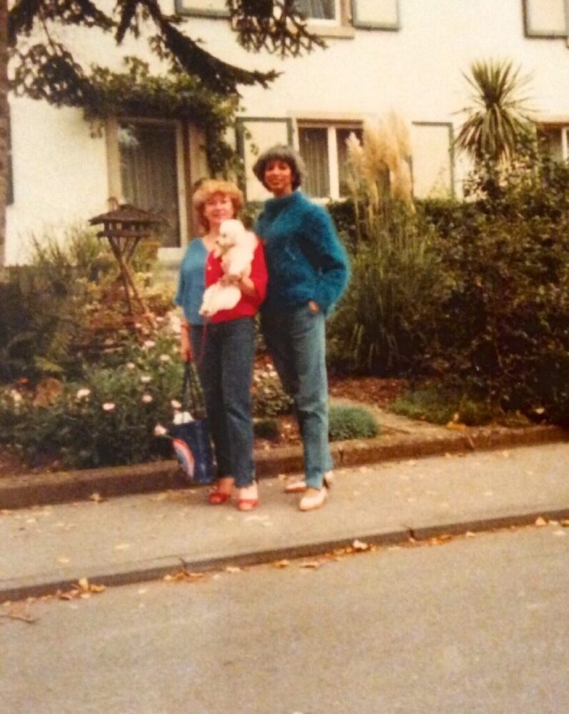 Download the full-sized image of A Photograph of Marlow Monique Dickson Standing on the Sidewalk with a Friend