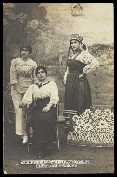 Download the full-sized image of Russian prisoners of war performing a show at a prisoner of war camp in Cottbus, with flower-bed prop. Photographic postcard, 191-.