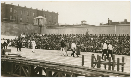 Download the full-sized image of Vaudeville Groups Walking Through Prison Yard