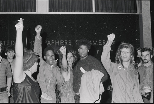 Download the full-sized image of A Photograph of Sylvia Rivera and Other Protesters with Fists Raised at Weinstein Hall Demonstration